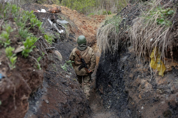 A Ukrainian service member walks in a trench at a position, as Russia?s attack on Ukraine continues, in Donetsk Region, Ukraine April 22, 2022.