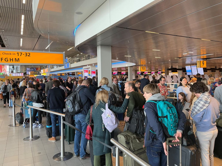 Travellers wait in lines at Amsterdam Schiphol Airport as an unannounced strike of ground staff caused many delays and cancellations, in Amsterdam, Netherlands April 23, 2022.