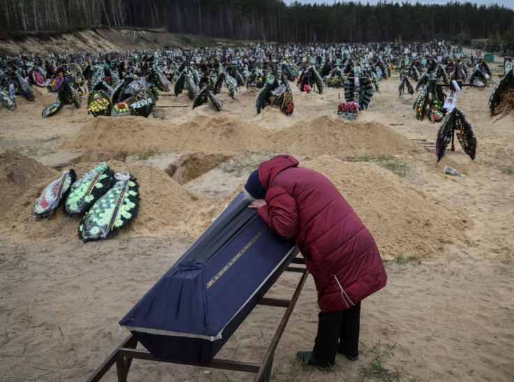 A woman reacts during a funeral of her relative, who died during the shelling by Russian troops, amid Russia's invasion of Ukraine, at the cemetery in Irpin, Kyiv region, Ukraine April 17, 2022.
