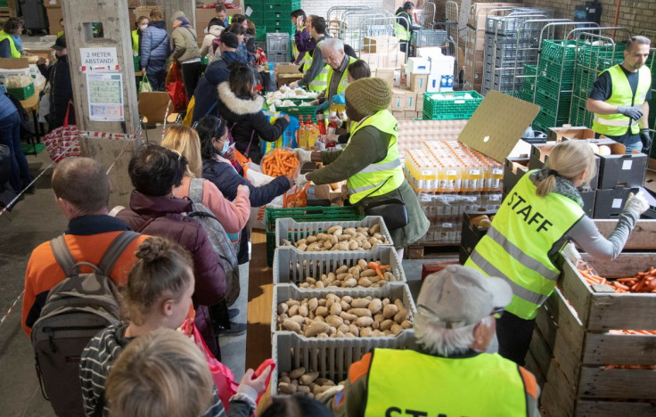 Volunteers give out food to people in need at a distribution depot of Swiss aid organisation "Essen fuer Alle" (Food For All) in Zurich, Switzerland April 23, 2022.