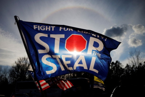 A "Stop the Steal" flag flies outside a campaign rally with U.S. President Donald Trump and Republican U.S. Senator Kelly Loeffler on the eve of Georgiaâs run-off election in Dalton, Georgia, U.S., January 4, 2021.   