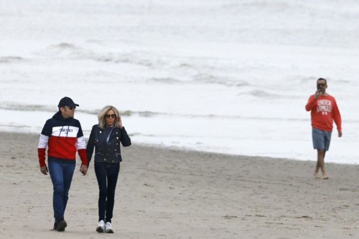 Macron and his wife Brigitte took a walk on the beach at le Touquet, northern France, on the eve of the vote