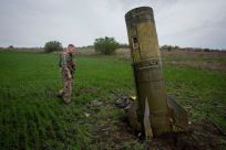A Ukrainian serviceman walks next to remains of a Russian Tochka U ballistic missile, as Russia's attack on Ukraine continues, in Kharkiv region, Ukraine, in this handout picture released April 23, 2022.  Press service of the Ukrainian Ground Forces/Hando