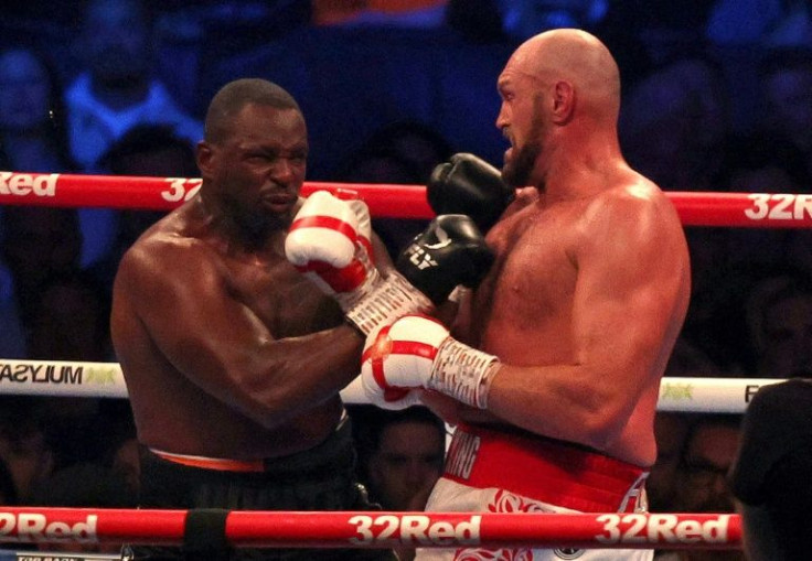 Tyson Fury (right) unleashes a fierce uppercut to stop Dillian Whyte in the sixth round of their all-British heavyweight title clash at Wembley