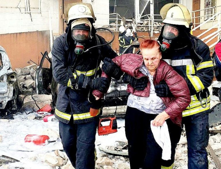 Rescuers carry a woman out of a damaged building after a missile strike in Odessa which Ukrainian authorities said killed at least eight people, including a baby, and wounded 18 others on April 23, 2022