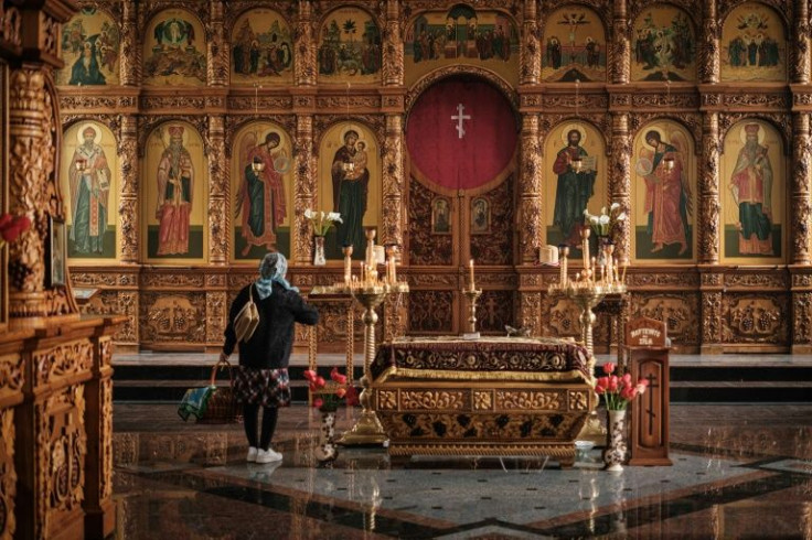 A woman carrying an Orthodox Easter basket prays at Holy Resurrection Church in Slovyansk, eastern Ukraine