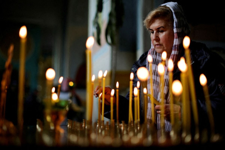 A Ukrainian woman takes part in an Easter Mass at the Ukrainian Orthodox Cathedral of the Holy Trinity, amid Russia's invasion of Ukraine, in Zaporizhzhia, Ukraine April 24, 2022. 