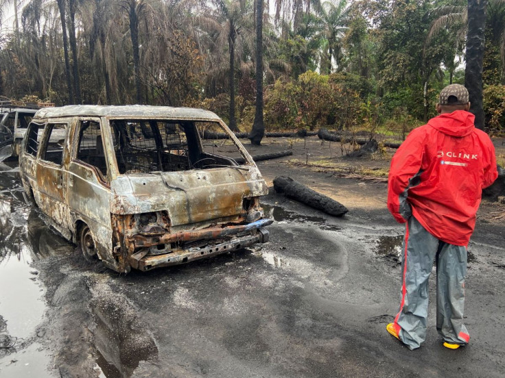 A man stands at the scene of explosion in which over 100 people lost their lives, at an illegal crude oil bunkering site at Abaezi forest, in Ohaji-Egbema Local Government Area of Imo state, Nigeria April 24, 2022.