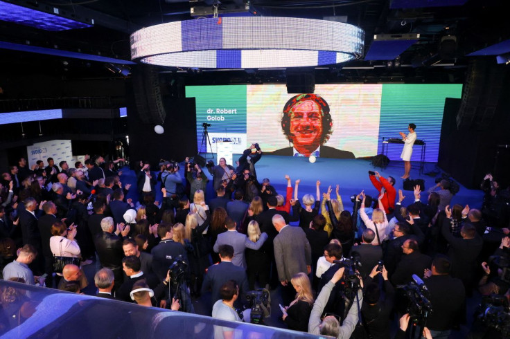 Leader of Gibanje Svoboda (Freedom Movement) Robert Golob appears on screen at the party base as people cheer while waiting for the results of the parliamentary election in Ljubljana, Slovenia April 24, 2022. 