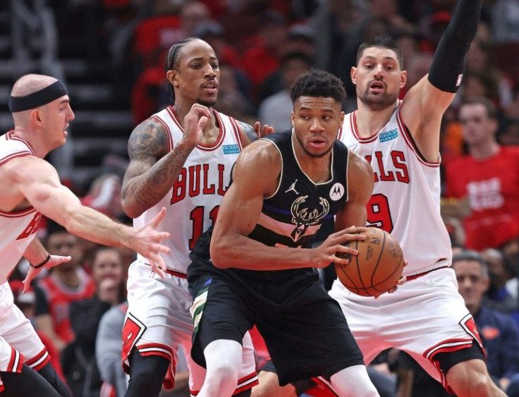 Milwaukee's Giannis Antetokounmpo is guarded by Chicago's Alex Caruso, left, DeMar DeRozan and Nikola Vucevic, right in Sunday's NBA playoff game