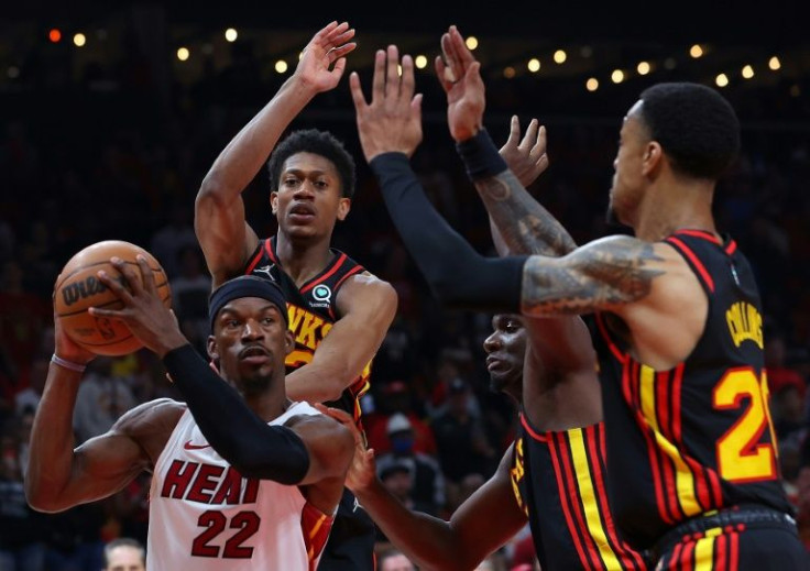 Miami's Jimmy Butler drives to the basket against De'Andre Hunter, Clint Capela and John Collins in the Heat's victory in game four of their NBA playoff series