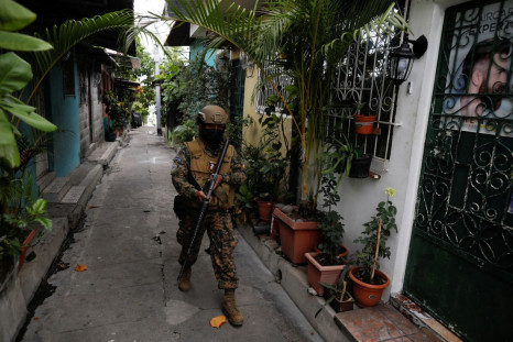 A soldier patrols at the 22 de Abril neighborhood after El Salvador's Congress approved on Sunday emergency powers that temporarily suspended some constitutional protections after the Central American country recorded a sharp rise in killings attributed t