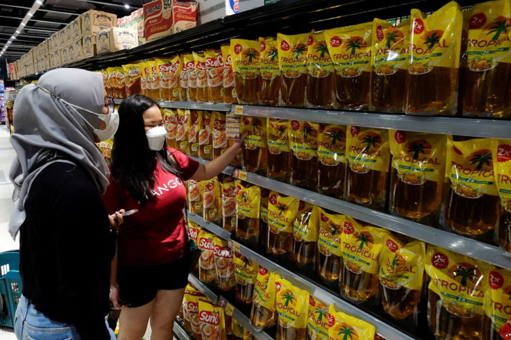 People shop for cooking oil made using palm oil at a supermarket in Jakarta, Indonesia, March 27, 2022.