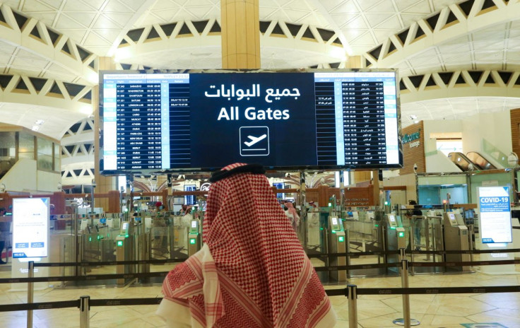 A Saudi man checks the flight timings at the King Khalid International Airport in Riyadh, Saudi Arabia, May 16, 2021. 