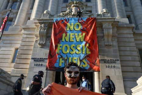 Activists from the climate group Extinction Rebellion demonstrate in front of the John Wilson district government building to demand an end to all new fossil fuel infrastructure in Washington, U.S., April 22, 2022. 