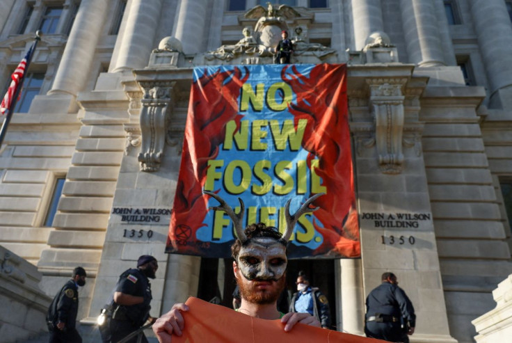 Activists from the climate group Extinction Rebellion demonstrate in front of the John Wilson district government building to demand an end to all new fossil fuel infrastructure in Washington, U.S., April 22, 2022. 