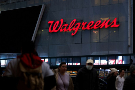 People walk by a Walgreens, owned by the Walgreens Boots Alliance, Inc., in Manhattan, New York City, U.S., November 26, 2021. 