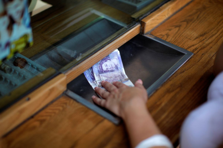 A woman exchanges English Pound notes at a money exchange office in the British overseas territory of Gibraltar, June 24, 2016.