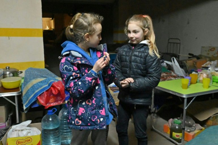 Lilia, 8, and her sister Alina, 9, moved into the car park  with their brother and parents just hours after the war began