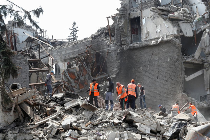Emergency management specialists and volunteers remove the debris of a theatre building destroyed in the course of Ukraine-Russia conflict in the southern port city of Mariupol, Ukraine April 25, 2022. 
