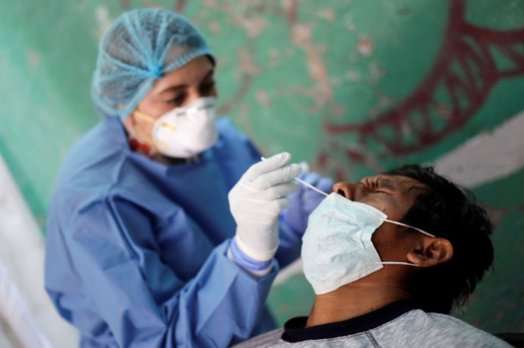 A man, part of a migrant caravan that arrived in the night in Mexico City, gets tested for the coronavirus disease (COVID-19) at the Basilica of Guadalupe's Pilgrims House in Mexico City, Mexico December 13, 2021. 