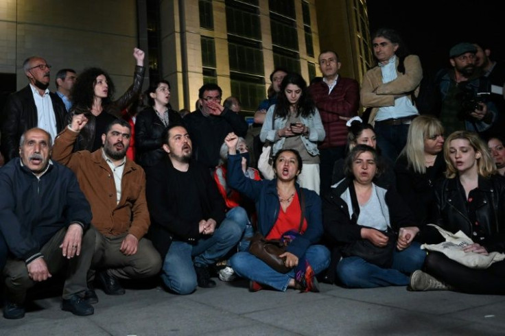 Demonstrators, including lawyers and opposition lawmakers chant slogans as they gather in front of Istanbul's courthouse after jailed civil society leader Osman Kavala was sentenced to life in prison on controversial charges, a verdict condemned by the US