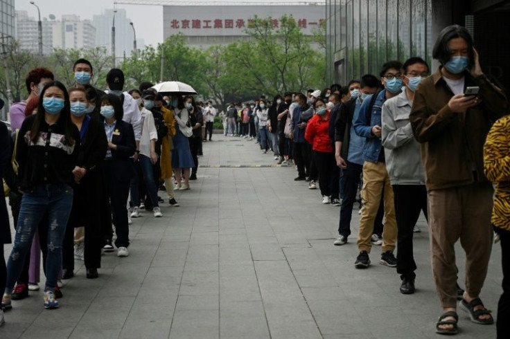 Beijing's most populous downtown district Chaoyang was the first to order mass testing from Monday, with people waiting in long lines to be swabbed by health workers