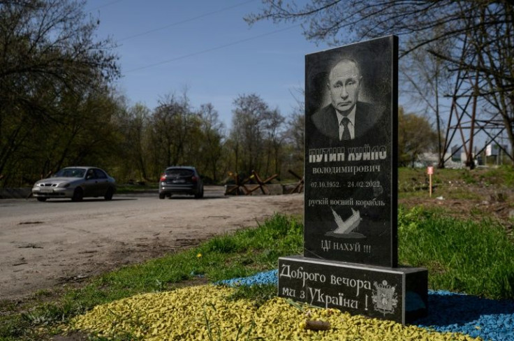 A mock tombstone portraying Russian President Vladimir Putin is displayed on a road outside Zaporizhzhia on April 25, 2022