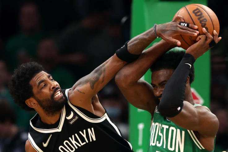 Kyrie Irving #11 of the Brooklyn Nets defends a shot from Jaylen Brown #7 of the Boston Celtics