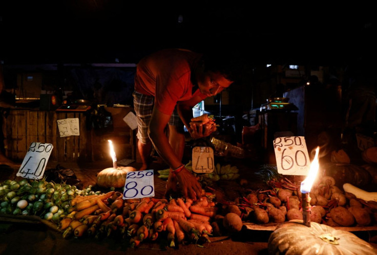 A vendor prepares a vegetables bag for a customer at the main market as the generator was broken, amid the country's economic crisis in Colombo, Sri Lanka, April 20, 2022. 