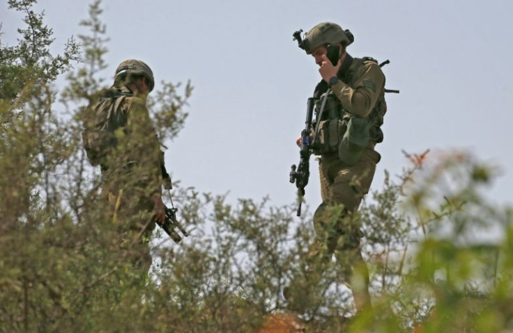 Israeli soldiers are positioned near the northern Israeli town of Metula along the border with Lebanon on April 25, 2022, following overnight rocket fire from Lebanon into northern Israel