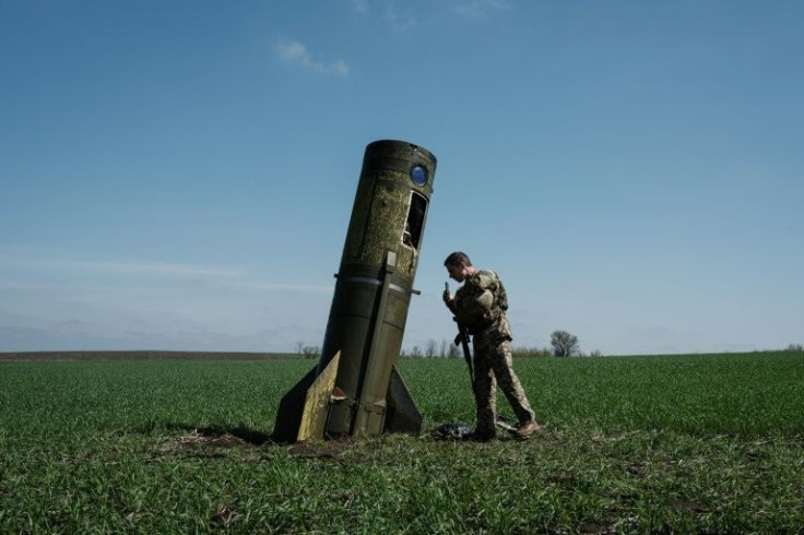 A Ukrainian serviceman looks at a Russian ballistic missile's booster stage that fell in a field in Bohodarove in eastern Ukraine. Kyiv is seeking more heavy weapons to fight back