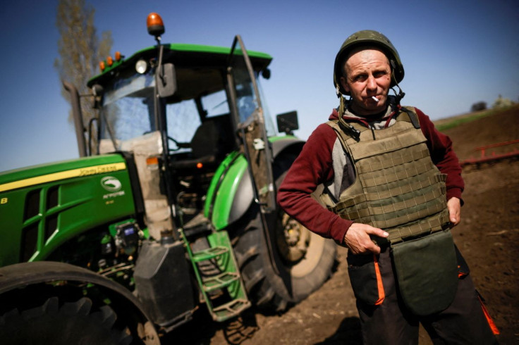 Yuri, a Ukrainian farmer, wearing body armor and helmet, works at the topsoil in a field, amid Russia's invasion of Ukraine, in Zaporizhzhia region, Ukraine April 26, 2022.