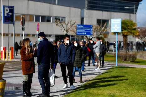 People queue to get tested for the coronavirus disease (COVID-19) after the Christmas holiday break, amid the COVID-19 pandemic, at Doce de Octubre Hospital in Madrid, Spain December 27, 2021. 