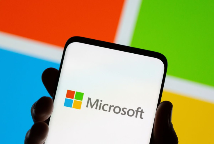 Smartphone is seen in front of Microsoft logo displayed in this illustration taken, July 26, 2021. 