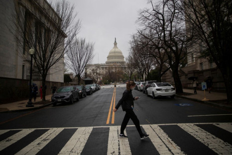 A visitor uses a crosswalk near the Longworth House Office Building on Capitol Hill in Washington, U.S., April 6, 2022. 