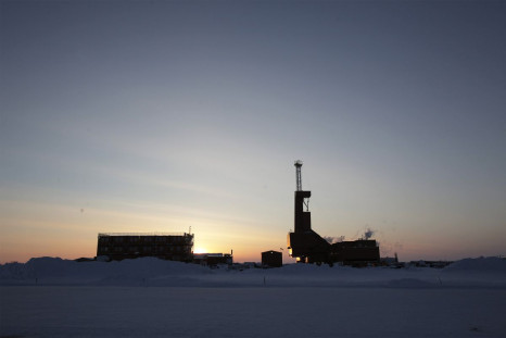 The sun sets behind an oil drilling rig in Prudhoe Bay, Alaska on March 17, 2011.  