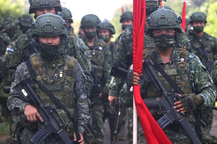 Soldiers march to position during an anti-invasion drill on the beach during the annual Han Kuang military drill in Tainan, Taiwan, September 14, 2021. 