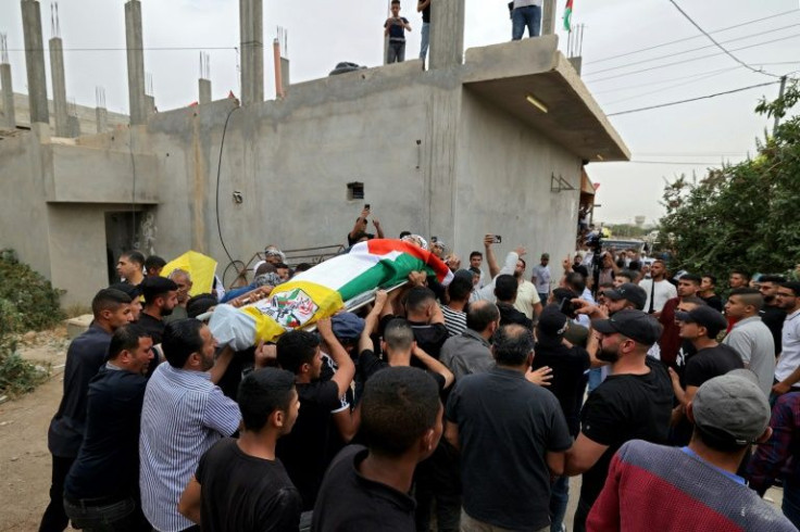 Palestinians carry the body of Ahmed Ibrahim Oweidat, during his funderal in Jericho in the occupied West Bank, on April 26, 2022