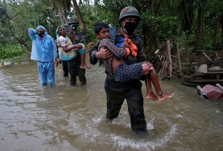 Army soldiers evacuate people from a flooded area to safer places as Cyclone Yaas makes landfall at Ramnagar in Purba Medinipur district in the eastern state of West Bengal, India, May 26, 2021. 