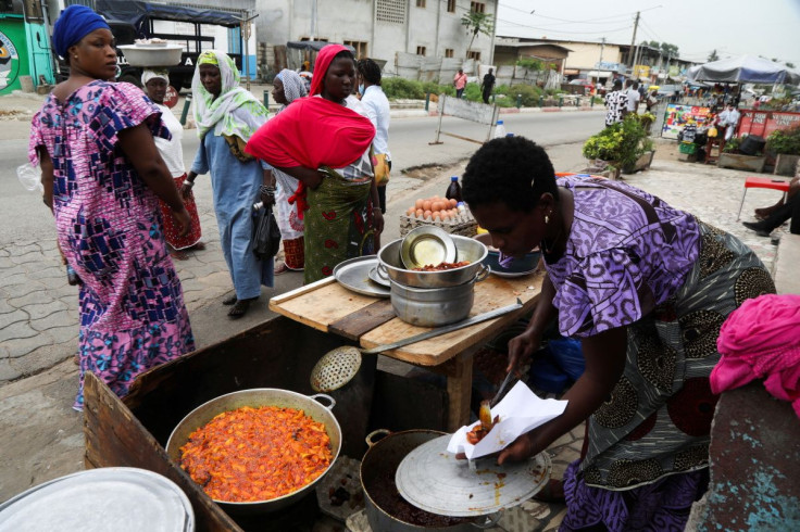 A woman sells plantains fried in crude palm oil, on a street in Abidjan, Ivory coast April 12, 2022. Picture taken April 12, 2022.