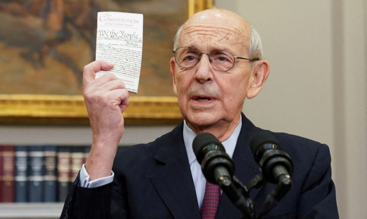 U.S. Supreme Court Justice Stephen Breyer holds up a copy of the U.S. Constitution as he announces he will retire at the end of the court's current term, at the White House in Washington, U.S., January 27, 2022. 