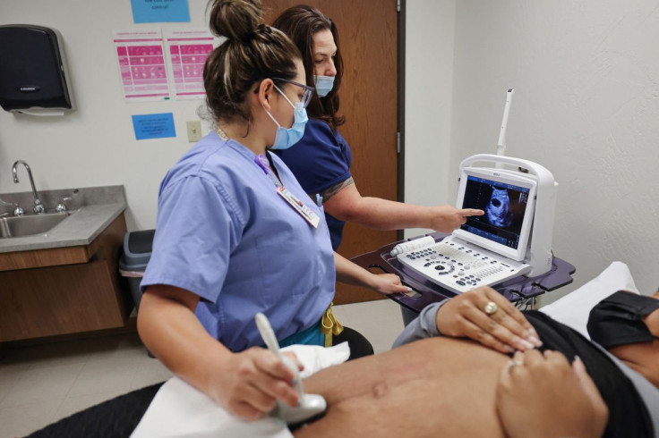 Taniya, an ultrasound sonographer, guides resident Dr. Ericka during an ultrasound on a patient from Austin, Texas, before her surgical abortion at the Trust Women clinic in Oklahoma City, U.S., December 6, 2021.  