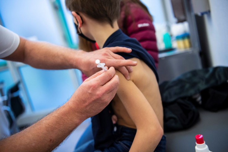 A boy gets children's dose of Comirnaty, the Pfizer-BioNTech vaccine against the coronavirus disease (COVID-19), at a vaccination centre in Ebersberg near Munich, Germany, December 15, 2021.