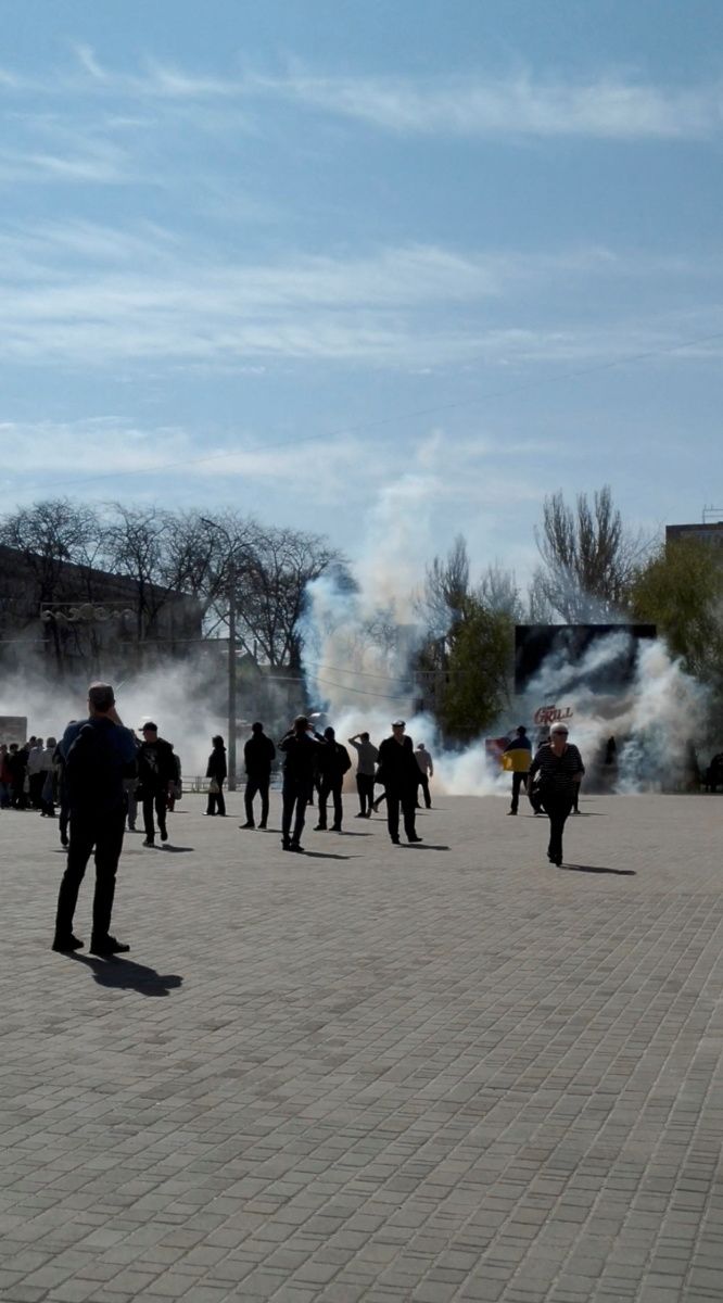 People flee as tear gas is fired during a protest, amid Russia's invasion of Ukraine, in Freedom Square, Kherson, Ukraine April 27, 2022 in this still image obtained by REUTERS from a social media video.  