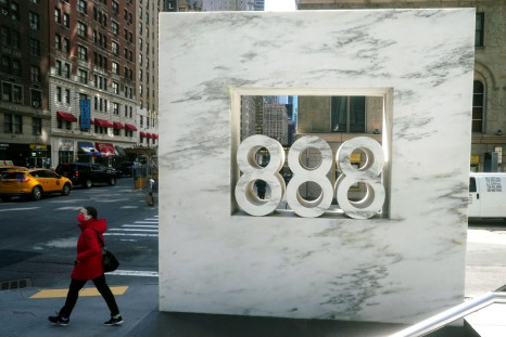 A person walks past 888 7th Ave, a building that reportedly houses Archegos Capital in the Manhattan borough of New York City, New York, U.S., March 29, 2021. 