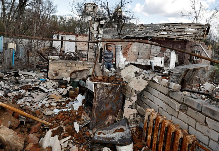 Olexandr Chernenko, 54, shows his neighbour's destroyed house, who according to him was killed by shrapnel, amid Russia's invasion of Ukraine, in Lukashivka, Chernihiv region, Ukraine April 27, 2022. 