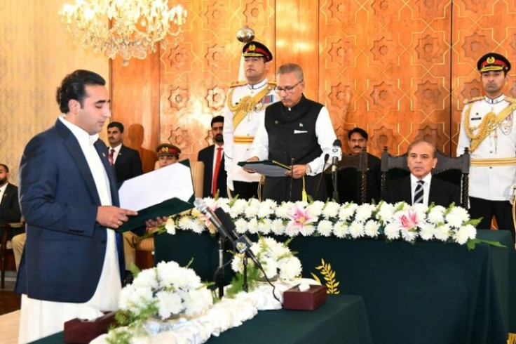 A handout photo released by Pakistan's Press Information Department (PID) shows Pakistan's President Arif Alvi administering the oath of office to new Foreign Minister Bilawal Bhutto Zardari in Islamabad