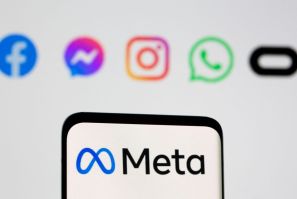 Facebook's new rebrand logo Meta is seen on smartpone in front of displayed logo of Facebook, Messenger, Intagram, Whatsapp, Oculus in this illustration picture taken October 28, 2021. 