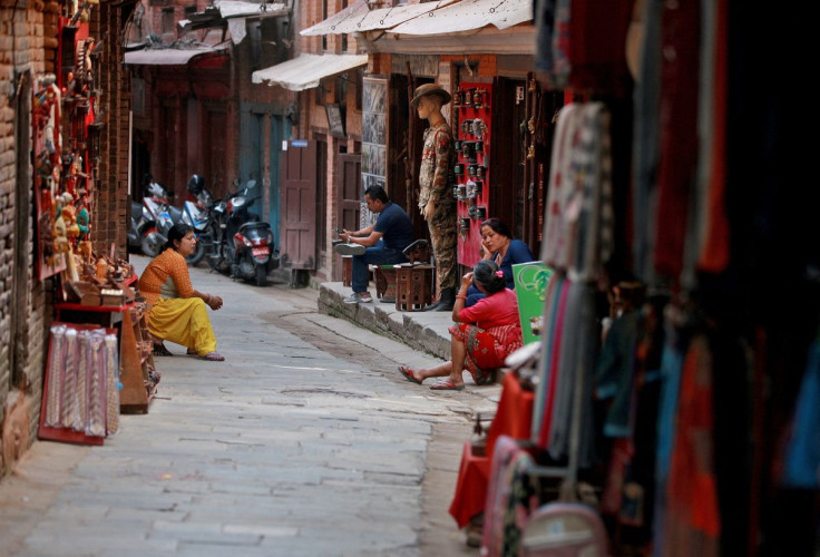 Souvenir shop owners wait for customers at an alley in Bhaktapur, Nepal April 24, 2022. Picture taken April 24, 2022.
